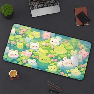 May include: A rectangular mousepad featuring a whimsical design of cartoon bears in shades of green, pink, and white, set against a backdrop of flowers and foliage. The mousepad has a black border and a white mouse is on the right side.