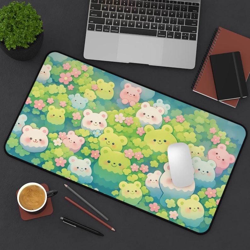 May include: A rectangular mousepad featuring a whimsical design of cartoon bears in shades of green, pink, and blue, surrounded by flowers. The mousepad has a black border and a white mouse is on top.