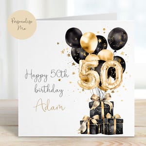 May include: A white card with gold and black balloons, a gold number 50, and black gift boxes. The card says "Happy 50th birthday Adam".