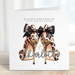 May include: A birthday card featuring a pair of leopard print high heels with black bows and gold detailing. The card includes the text "Happy Birthday To My Special Friend" and the name "Charlotte" in cursive script.