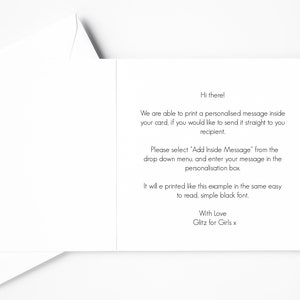 May include: Open white greeting card with text. The card's interior displays instructions for adding a personalized message. The text is in a simple black font. The card is from "Glitz for Girls x".