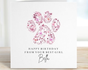 May include: A white card with a pink floral paw print design. The text "Happy Birthday from your best girl Bella" is written below the paw print.