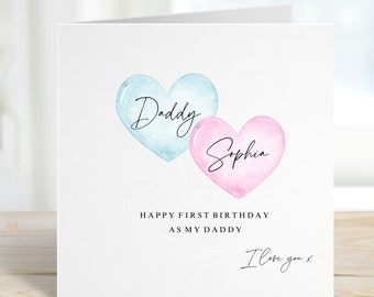 May include: A white card with two watercolor hearts, one blue and one pink. The blue heart says "Daddy" and the pink heart says "Sophia". The card says "Happy First Birthday as my Daddy. I love you x"