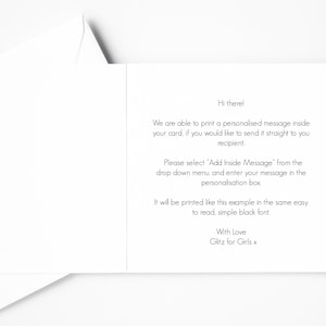 May include: A white greeting card, opened to reveal printed text. The text includes instructions for adding a personalized message, with the phrase "Hi there!" at the top and "With Love Glitz for Girls x" at the bottom.