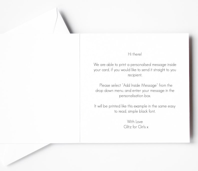 May include: A white greeting card, opened to reveal printed text. The text includes instructions for adding a personalized message, with the phrase "Hi there!" at the top and "With Love Glitz for Girls x" at the bottom.