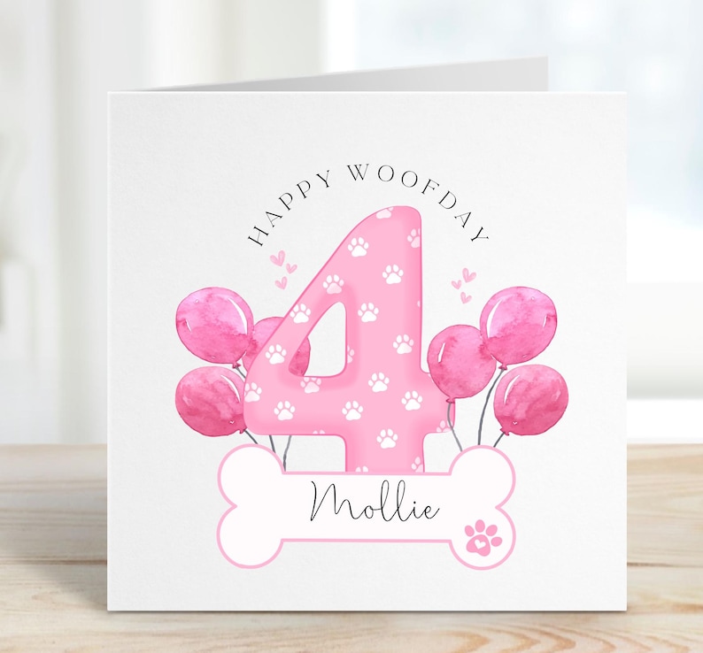 May include: Pink birthday card featuring a large number 4 with paw prints, surrounded by pink balloons. The card reads "Happy Woofday" and has a bone with the name "Mollie" on it.