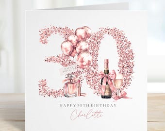 May include: A white birthday card with a rose gold glitter design forming the number 30. The card features illustrations of balloons, perfume, a champagne bottle, and a glass of champagne. The text reads "Happy 30th Birthday Charlotte."