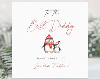 May include: A Christmas card with a red and white penguin illustration. The card reads "To the Best Daddy" and "Happy Christmas" with a handwritten message "Love from Freddie x".