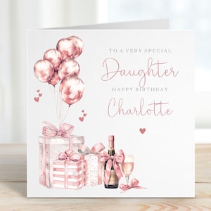 May include: A birthday card with a watercolor design. The card features pink balloons, gift boxes, a champagne bottle, and a glass. Text reads "To a very special Daughter Happy Birthday Charlotte."