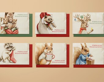 Könnte beinhalten: Sechs Weihnachtskarten mit Tierillustrationen. Jede Karte zeigt ein anderes Tier, wie ein Eichhörnchen und ein Reh, mit dem Text "Fröhliche Weihnachten". Die Karten haben rote und grüne Ränder und einen Vintage-Look.
