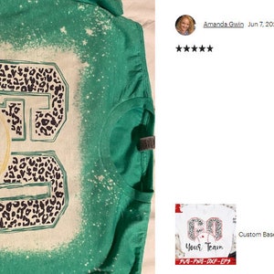 May include: A green t-shirt with a bleached design featuring a baseball and the text "AUM ALL STARS" in a black and white leopard print.