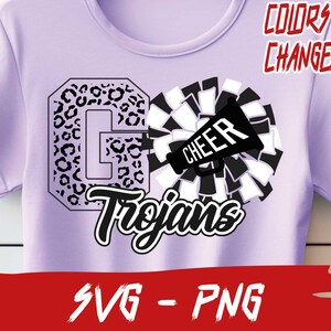 May include: A purple t-shirt with a black and white design. The design features a large letter "G" with a leopard print pattern, a cheerleading pom-pom, and a megaphone with the word "CHEER" on it. The text "Trojans" is written in a black cursive font below the design. The text "COLORS ARE CHANGEABLE" is written in red at the top of the image. The text "SVG - PNG" is written in red at the bottom of the image.