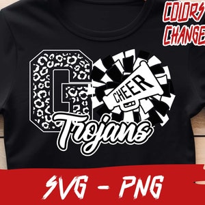 May include: Black and white graphic design featuring a cheerleading megaphone with the word "CHEER" on it, a large letter "G" with a leopard print pattern, and the word "Trojans" in a stylized font. The text "COLORS ARE CHANGEABLE" appears above the design. The design is on a black t-shirt.
