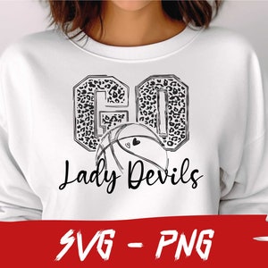 May include: A white sweatshirt with a black and white graphic design of a basketball with the words "Go Lady Devils" in a leopard print pattern.
