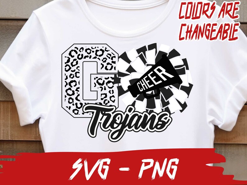 May include: White t-shirt with a black and white graphic design. The graphic features a large letter "G" with a leopard print pattern, the word "Trojans" in a stylized font, and a black and white cheerleader pom-pom with a megaphone that says "Cheer".