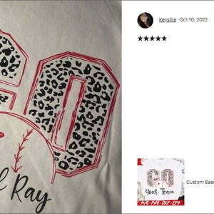 May include: A white t-shirt with a red outline of the number "60" filled with a black and white leopard print design. The number is above a red baseball with two small hearts and the text "Devil Ray" below.