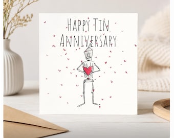 May include: A square greeting card with a white background featuring a black ink illustration of a robot holding a red heart. The text "HAPPY TIN ANNIVERSARY" is printed in black above the robot, surrounded by small, scattered red hearts.