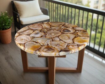 May include: A round, brown and white agate coffee table with a wooden base. The table top is made of polished agate slices, creating a unique and natural look.
