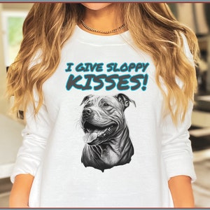 May include: White sweatshirt with a black and white illustration of a pit bull dog. The text "I give sloppy kisses!" is printed in blue on the sweatshirt.