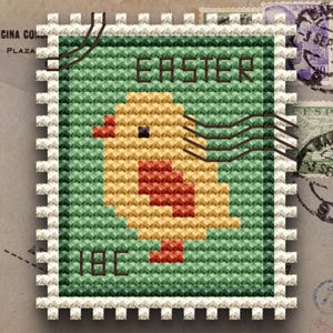 May include: A cross-stitch design of an Easter-themed postage stamp. The stamp features a yellow and red chick against a green background, with the word "EASTER" above and "18¢" below. The stamp has a white, perforated border.