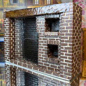 May include: A miniature brick fireplace with a brown wooden mantel and two black brick openings. The fireplace is made of brown and white painted bricks.