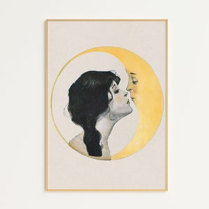 May include: A framed vintage art print featuring a woman and a crescent moon in a romantic embrace. The woman has dark hair and is facing the moon, which has a yellow face. The artwork is set against a cream background.