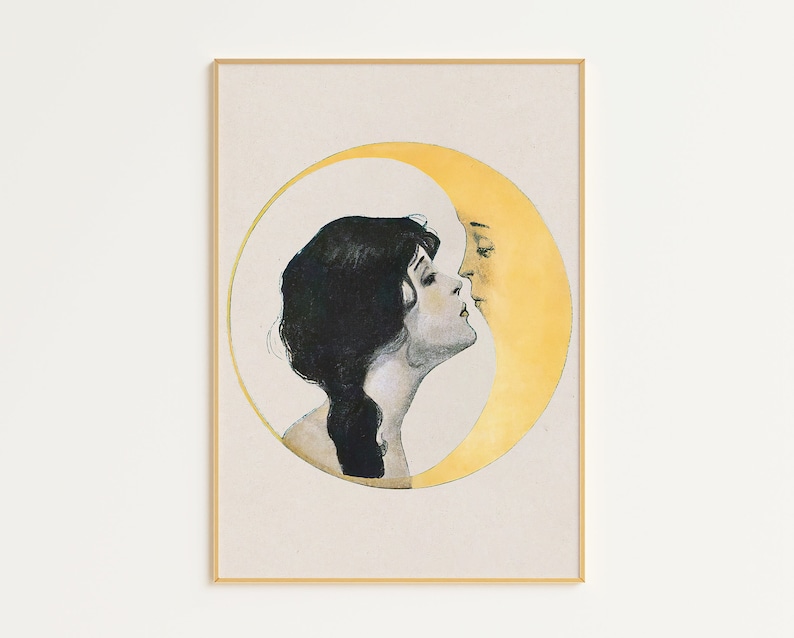 May include: A framed vintage art print featuring a woman and a crescent moon in a romantic embrace. The woman has dark hair and is facing the moon, which has a yellow face. The artwork is set against a cream background.