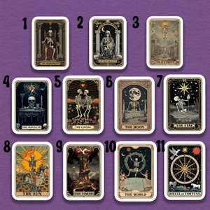 May include: A set of 11 tarot cards featuring skeletons in various poses and settings. The cards are numbered 1 through 11 and include titles such as "The Magician", "The Hierophant", "The Lovers", "The Moon", "The Star", "The Sun", "The Tower", "The World", and "Wheel of Fortune".