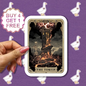 May include: A tarot card with a dark background and a gold frame. The card depicts a tower on fire with lightning striking it. A skeleton stands near the tower. The card is labeled "The Tower".