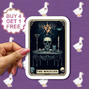 May include: A tarot card with a dark background featuring a skull on a table with a candle, a goblet, and other objects. The card is titled "The Magician".