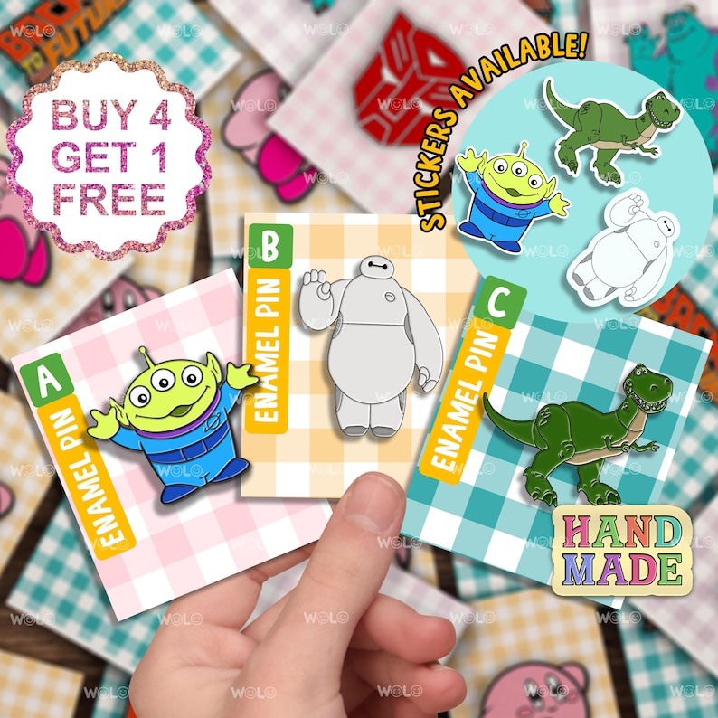 May include: Four enamel pins featuring characters from popular animated films. The pins are displayed on colorful cards with the letters A, B, and C. The characters are:  a green alien with three eyes, a white robot, a green dinosaur, and a handmade sign that says "HAND MADE".