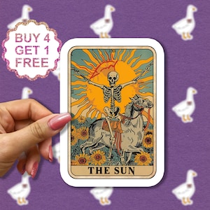 May include: A tarot card with a yellow sun and a skeleton riding a white horse. The card is titled "THE SUN".