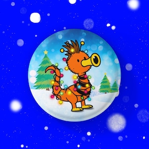 May include: A cartoon illustration of an orange creature with a long snout, adorned with Christmas lights. It's set within a snow globe, featuring Christmas trees and a snowy landscape, against a blue backdrop with falling snowflakes.