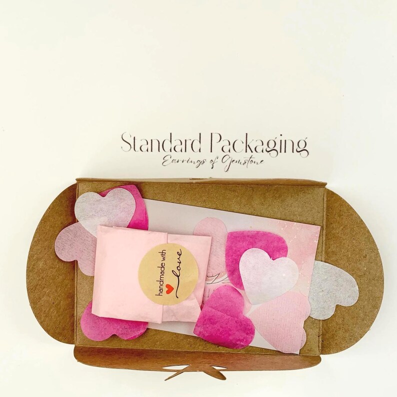 Standard packaging with natural card envelope, shops card and shades of pink confetti
