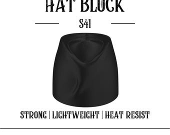 May include: A black hat block with the text "HAT BLOCK S41". The hat block is a solid, rounded shape with a curved top. The text "STRONG | LIGHTWEIGHT | HEAT RESIST" is below the hat block. The website address is at the bottom.