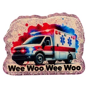 May include: A glittery badge in an irregular shape, depicting an ambulance with red and blue hues. The ambulance is white with red stripes and blue star-of-life symbols. The text "Wee Woo Wee Woo" is displayed at the bottom.
