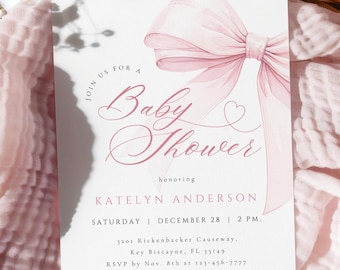 May include: A pink baby shower invitation with a watercolor illustration of a pink bow. The invitation reads "Join us for a Baby Shower honoring Katelyn Anderson Saturday December 28 | 2 PM. 3201 Rickenbacker Causeway. Key Biscayne, FL 33149 RSVP by Nov. 8th at 123-456-7777 Registered at Store Name"