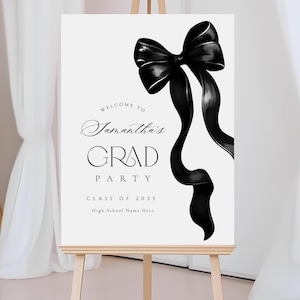 May include: A white sign on an easel with a black bow illustration. The sign reads "Welcome to Samantha's Grad Party Class of 2025" with space for a high school name. The bow has flowing ribbons.