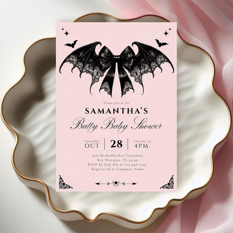 May include: A pink baby shower invitation with a black bat wing bow design. The invitation reads "SAMANTHA'S Batty Baby Shower" with the date and time. The invitation is on a white and gold decorative plate.