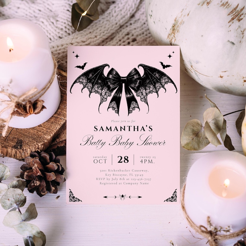 May include: A pink baby shower invitation with a black bat wing bow design. The invitation includes the text "SAMANTHA'S Batty Baby Shower" and event details. The invitation is surrounded by candles, a pumpkin, and decorative elements.