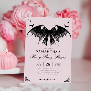 May include: A pink baby shower invitation with a black bat-wing bow design. The invitation reads "SAMANTHA'S Batty Baby Shower" with the date and time. Decorative bats and stars are at the top. The invitation is surrounded by pink flowers.