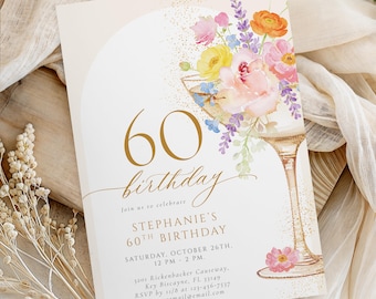 May include: A 60th birthday invitation card featuring a watercolor illustration of a cocktail glass filled with colorful flowers, gold glitter accents, and elegant gold text that reads 60 birthday, Stephanie's 60th Birthday, and event details.