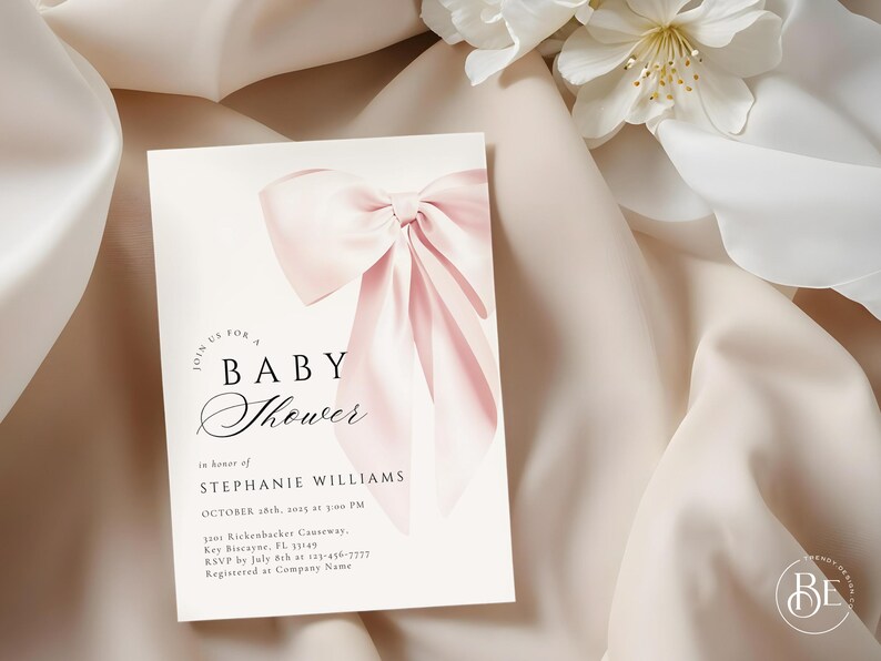May include: A pink baby shower invitation with a large pink bow in the center. The text reads "Join us for a Baby Shower in honor of Stephanie Williams, October 28th, 2023 at 3:00 PM, 3101 Rickenbacker Causeway, Key Biscayne, FL 33149, RSVP by July 8th at 123-456-7777, Registered at Company Name."
