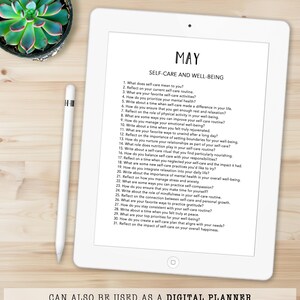 May include: A digital planner on a white tablet with the title "MAY SELF-CARE AND WELL-BEING." The screen displays a list of self-care prompts. A succulent plant and a stylus are visible. Text at the bottom reads "CAN ALSO BE USED AS A DIGITAL PLANNER."
