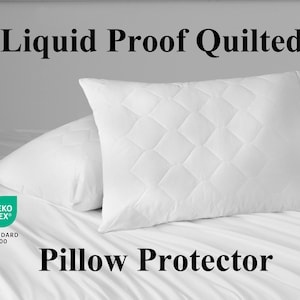 May include: Two white, quilted pillow protectors on a bed. The pillows have a diamond pattern and are labeled "Liquid Proof Quilted Pillow Protector". The image also includes the Oeko-Tex Standard 100 logo.