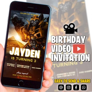 May include: A smartphone screen displaying a birthday video invitation for Jayden's 3rd birthday. The invitation features a yellow robot character with a black background. The text "Calling all Autobots" is at the top of the screen. The invitation includes the date, time, and location of the party. The text "Birthday Video Invitation" is displayed in large, bold letters at the top of the screen.