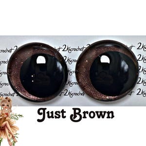 May include: Two brown and black safety eyes with a glitter finish. The eyes are approximately 1 inch in diameter.