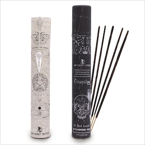 May include: Two cylindrical incense containers and a bundle of incense sticks. One container is off-white with a butterfly and pentagram design, the other is black with a skull graphic. The text "Ancient Witch" is visible on both.