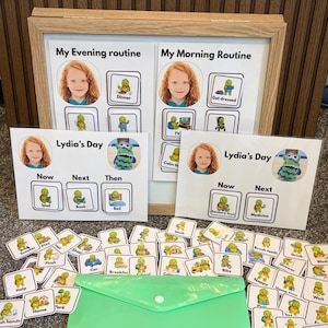 May include: A set of laminated visual schedule boards and cards featuring a child's photo, a green turtle character, and text labels like My Evening Routine, My Morning Routine, and Lydia's Day, stored in a light green plastic envelope.