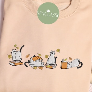 Embroidered Cat Playing with Books in Autumn Leaves Sweatshirt, Halloween Ghost Cat and Book, Book Crewneck, Fall Clothing, Cat Lover Gifts